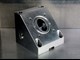 Side view of triangular machined part with hole in the center